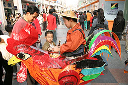 Man in chicken costume selling candied olives